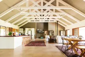 Modern barndominium and subtle upward graph symbolizing long-term property value in Texas.