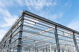 Comparison of steel and wood building frames showing strength and durability.