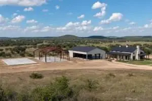 Four-stage time-lapse composite showing barndominium construction from foundation slab to completed home on rural Texas ranch land